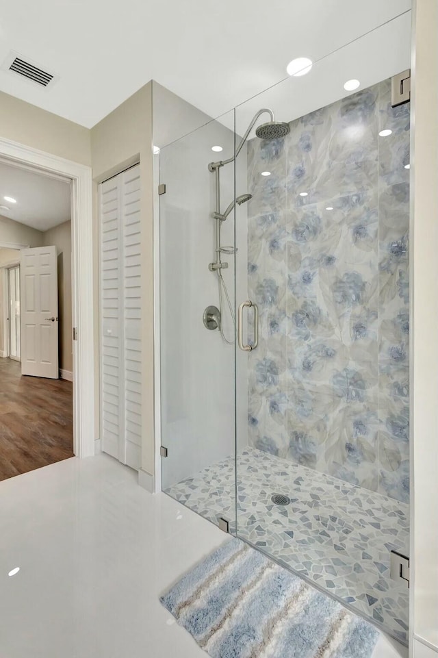 bathroom featuring visible vents, a closet, and a shower stall