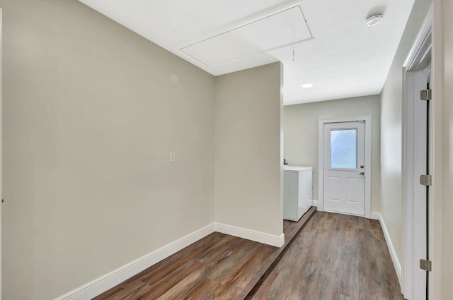 interior space with attic access, baseboards, dark wood-style flooring, and washer / dryer