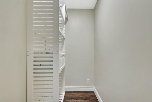 stairway with baseboards and wood finished floors