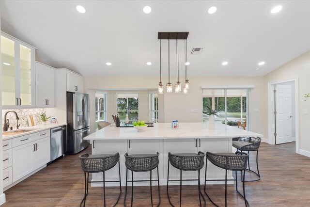 17393 84th Ct N, Loxahatchee, FL 33470 - kitchen with appliances with stainless steel finishes, a sink, recessed lighting, a kitchen island, and white cabinets