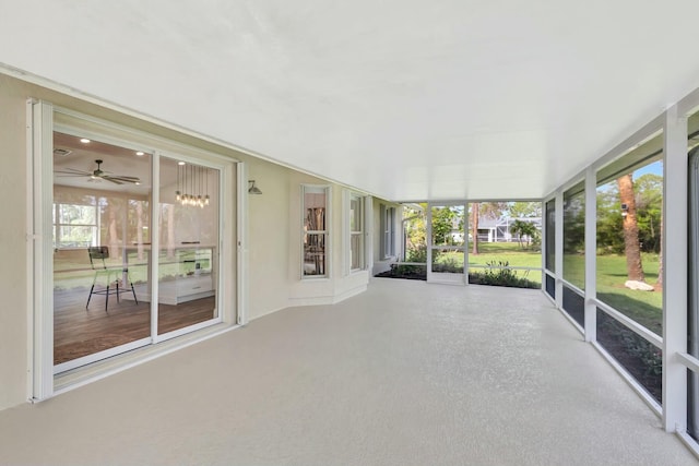 unfurnished sunroom featuring ceiling fan