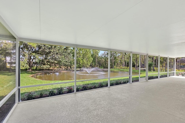 unfurnished sunroom featuring a water view