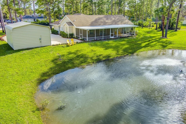 17393 84th Ct N, Loxahatchee, FL 33470 - back of property featuring a sunroom, a lawn, concrete driveway, and a water view