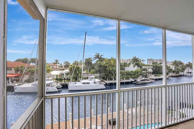 unfurnished sunroom with a water view