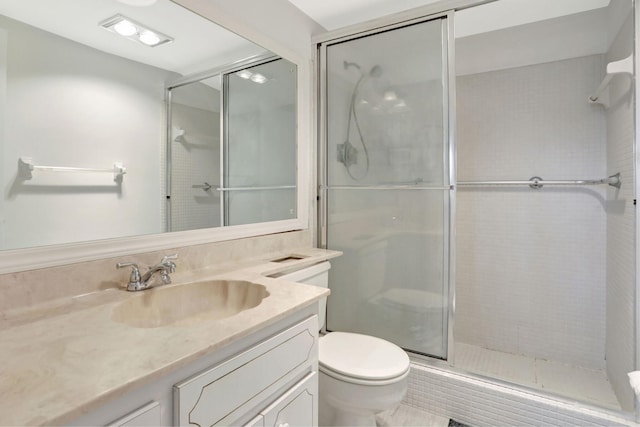 full bath featuring vanity, toilet, and a shower stall