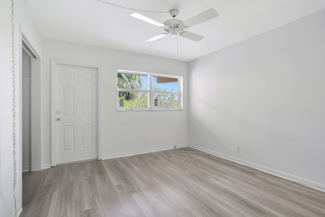 unfurnished bedroom featuring baseboards, light wood-style floors, and ceiling fan