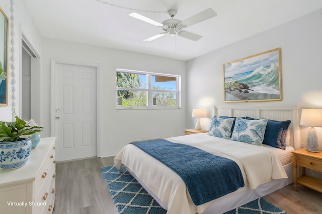 bedroom with a ceiling fan and light wood-type flooring