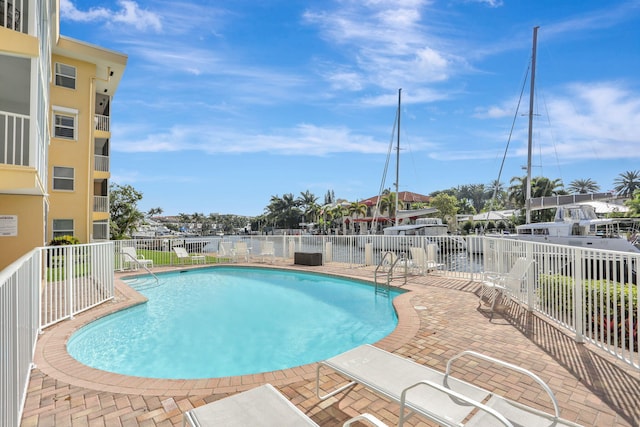 pool featuring a patio and fence