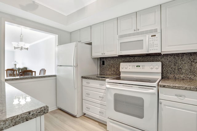 kitchen featuring light wood-style flooring, backsplash, white appliances, an inviting chandelier, and white cabinets