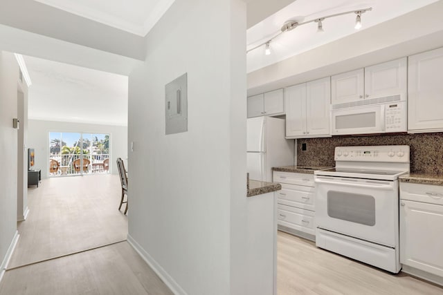 kitchen with white appliances, light wood finished floors, electric panel, white cabinetry, and tasteful backsplash