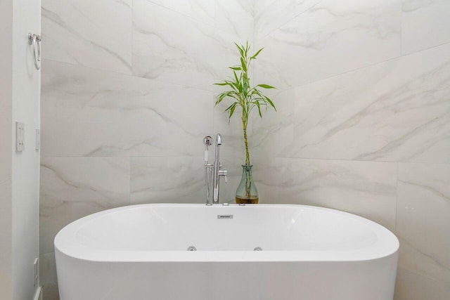 full bath featuring tile walls and a freestanding tub