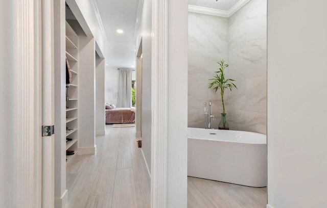 corridor with tile walls, recessed lighting, and crown molding