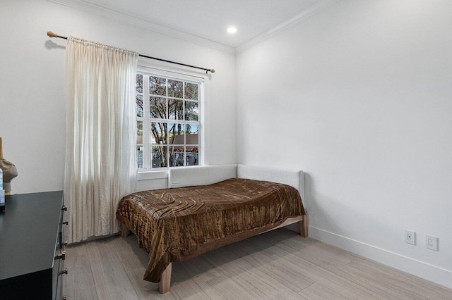 bedroom with recessed lighting, crown molding, baseboards, and wood finished floors