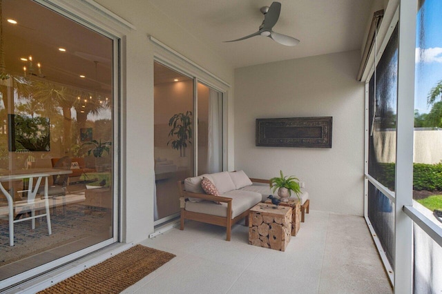 sunroom / solarium featuring a ceiling fan