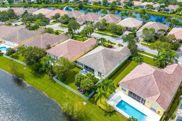 drone / aerial view featuring a residential view and a water view