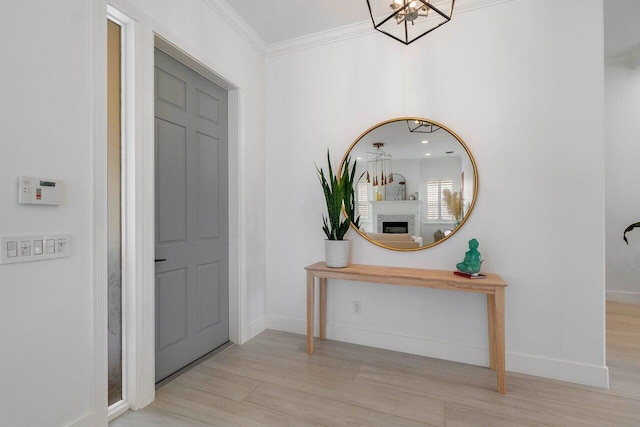 corridor with wood finished floors, baseboards, and ornamental molding