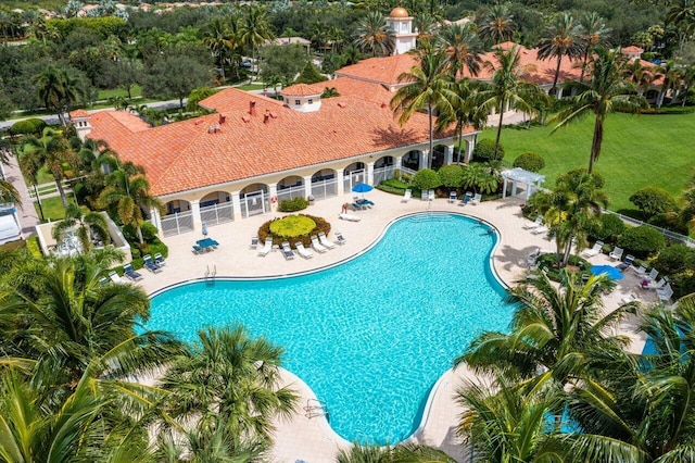 pool featuring fence, a lawn, and a patio area