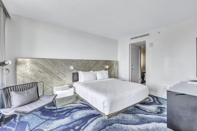 bedroom with baseboards and visible vents