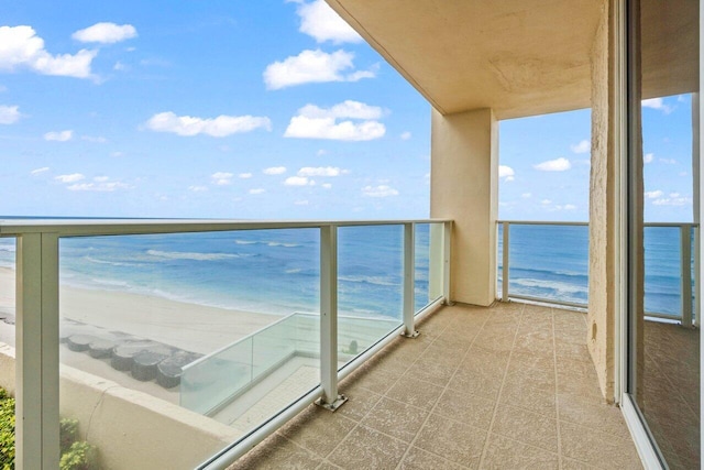 balcony with a view of the beach and a water view