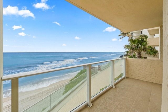 balcony with a beach view and a water view