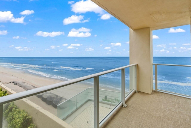 balcony with a beach view and a water view