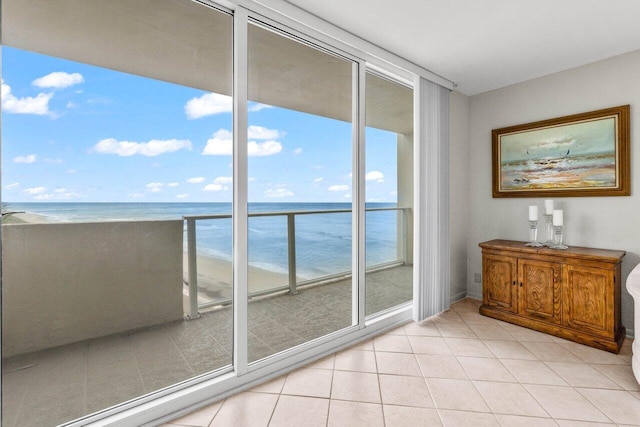 doorway featuring light tile patterned floors and a water view