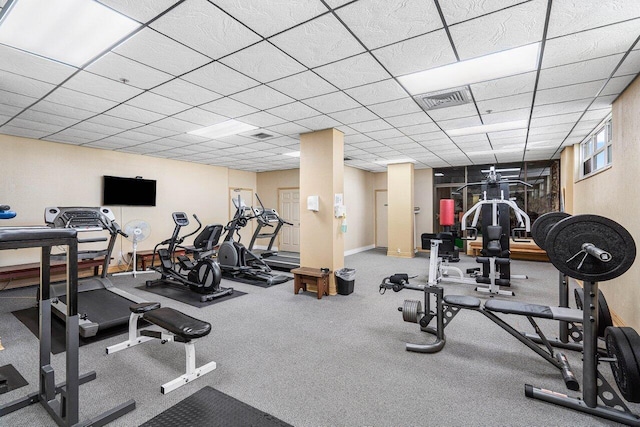 gym with a drop ceiling, visible vents, and baseboards