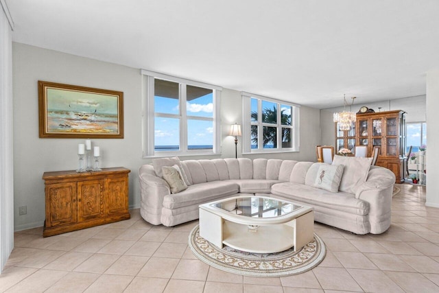 living area with light tile patterned floors and a chandelier