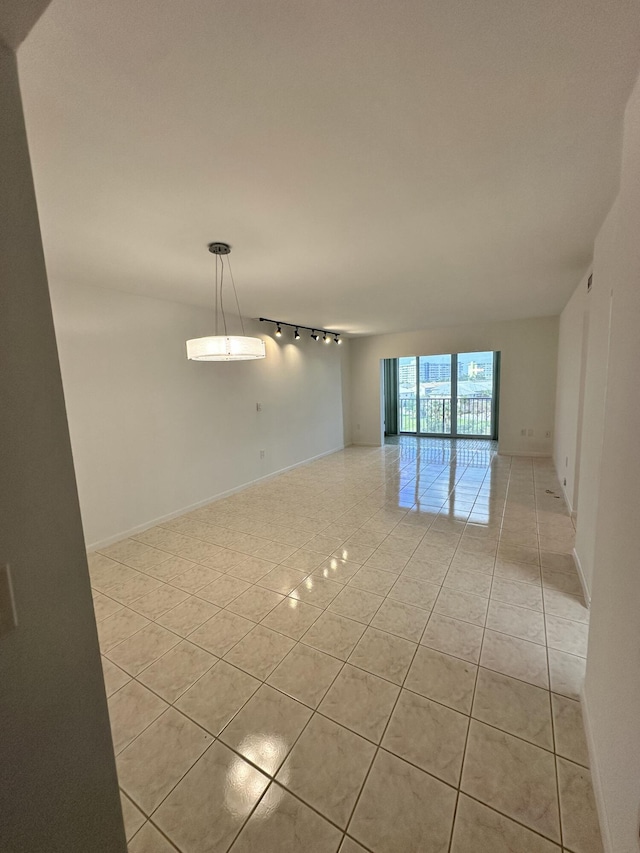 3850 Washington St Unit 510, Hollywood, FL 33021 - spare room featuring track lighting and light tile patterned flooring