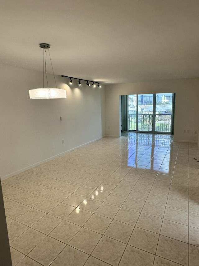 3850 Washington St Unit 510, Hollywood, FL 33021 - unfurnished room with baseboards, rail lighting, and light tile patterned flooring