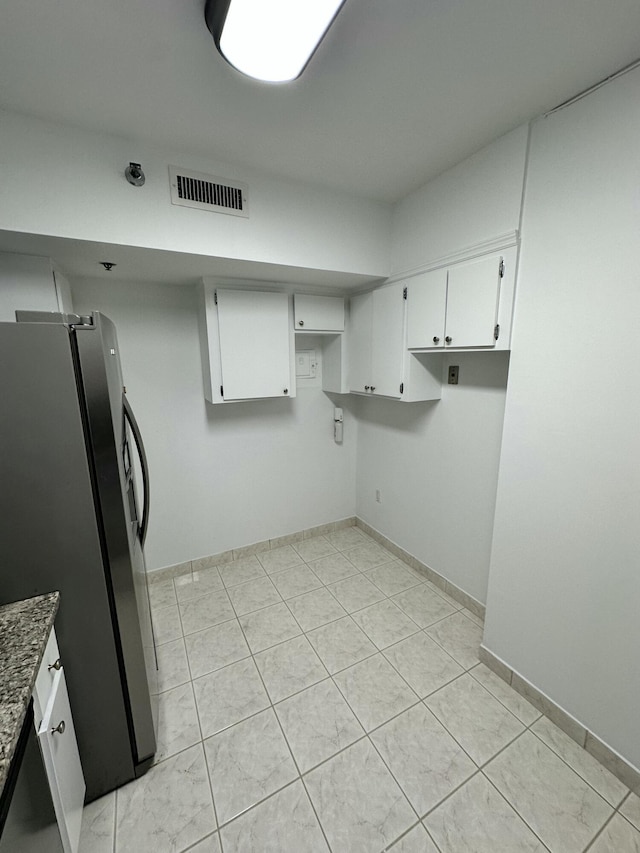 3850 Washington St Unit 510, Hollywood, FL 33021 - kitchen featuring freestanding refrigerator, stone counters, white cabinetry, visible vents, and baseboards