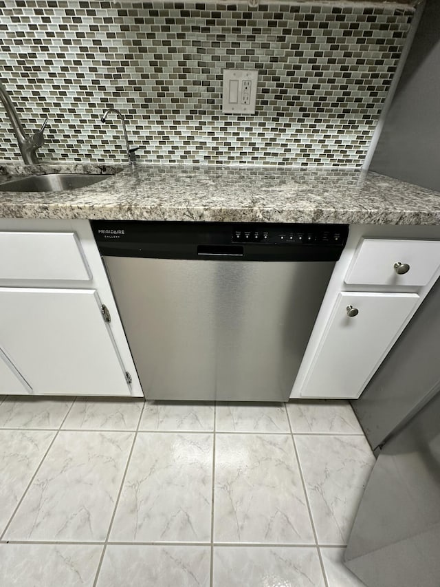 3850 Washington St Unit 510, Hollywood, FL 33021 - details with dishwasher, a sink, white cabinetry, decorative backsplash, and light stone counters