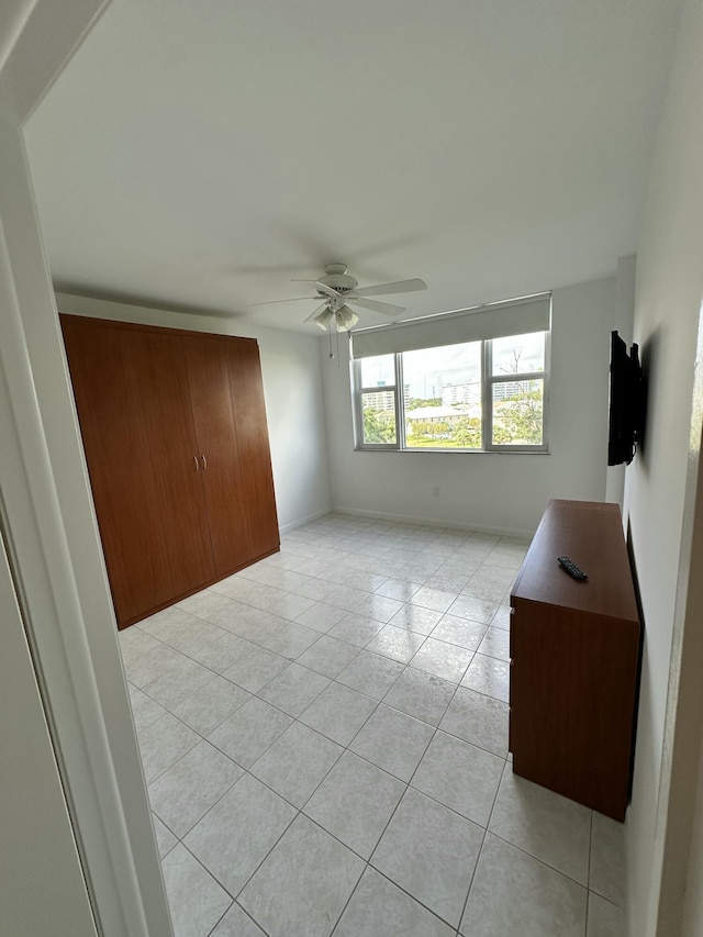 3850 Washington St Unit 510, Hollywood, FL 33021 - unfurnished bedroom with light tile patterned floors, baseboards, and a ceiling fan