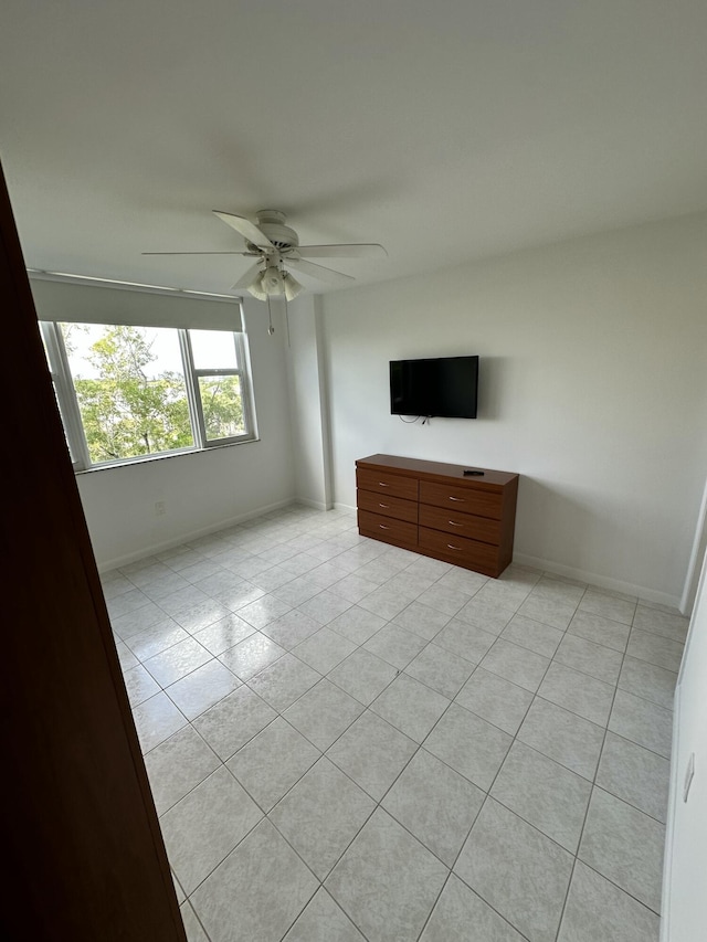 3850 Washington St Unit 510, Hollywood, FL 33021 - unfurnished bedroom featuring light tile patterned floors, baseboards, and a ceiling fan