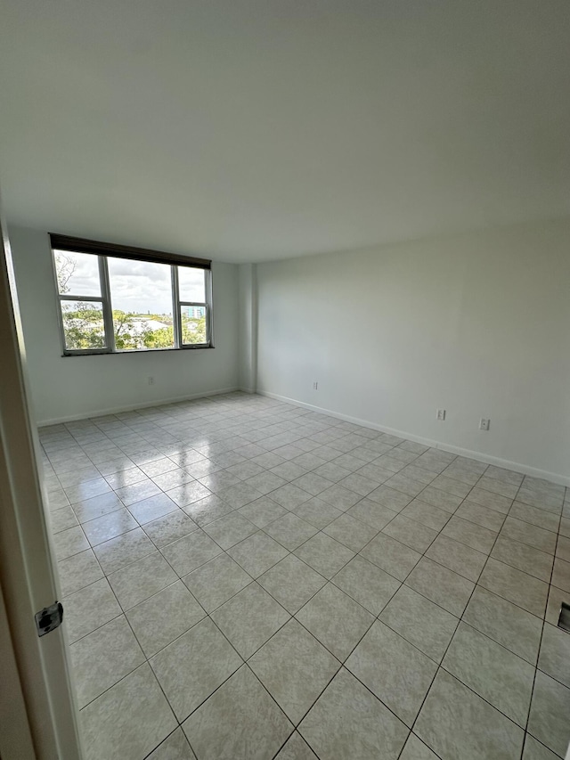 3850 Washington St Unit 510, Hollywood, FL 33021 - empty room featuring light tile patterned flooring and baseboards