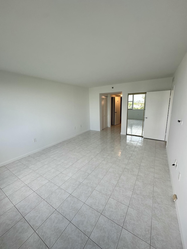 3850 Washington St Unit 510, Hollywood, FL 33021 - spare room with light tile patterned floors and baseboards