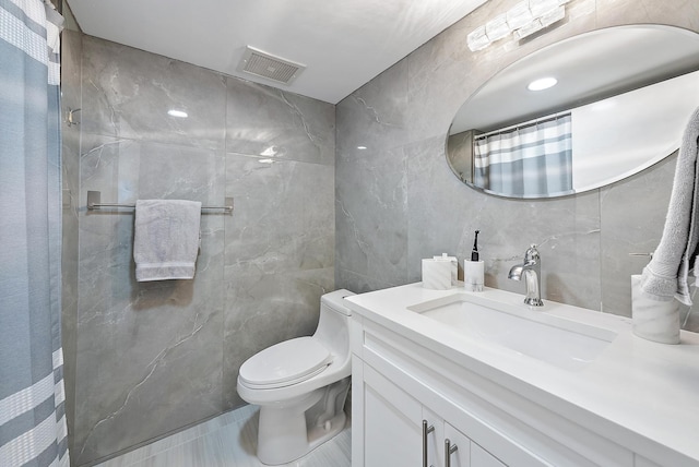 full bathroom featuring vanity, visible vents, curtained shower, tile walls, and toilet