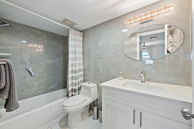 full bath with visible vents, tile walls, toilet, shower / bath combo with shower curtain, and vanity