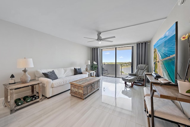 living room with a wall of windows and ceiling fan