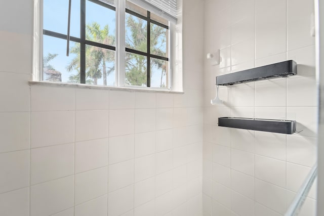 bathroom with tiled shower