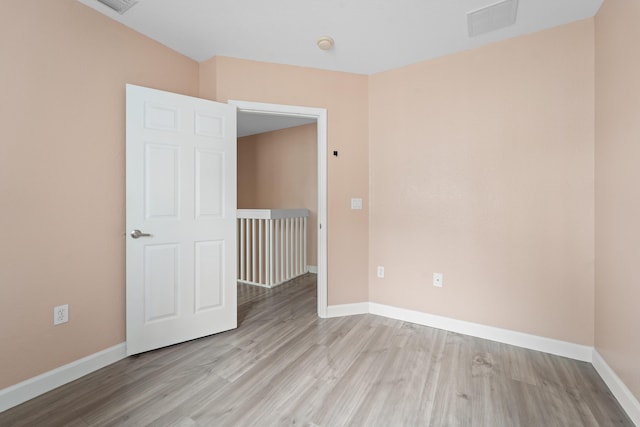 empty room with visible vents, baseboards, and light wood-style flooring