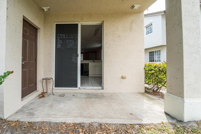 doorway to property featuring stucco siding