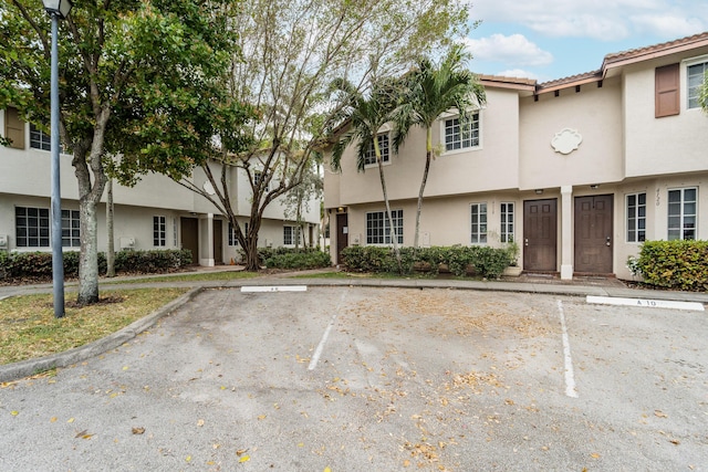 view of property with uncovered parking