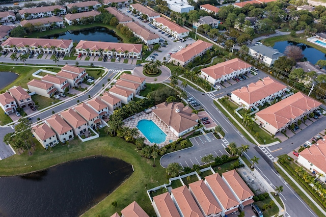 drone / aerial view with a residential view and a water view