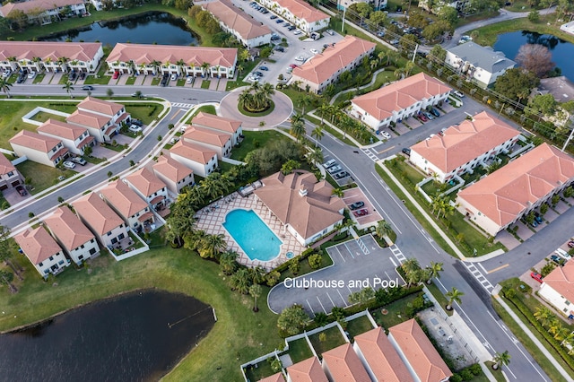 drone / aerial view featuring a residential view and a water view