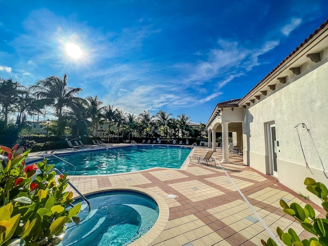 pool with a community hot tub and a patio