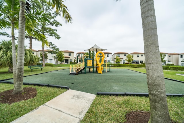 community playground with a residential view and a yard