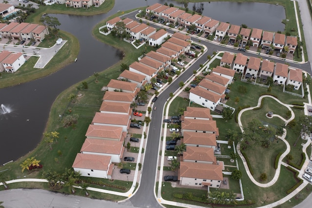 drone / aerial view with a residential view and a water view