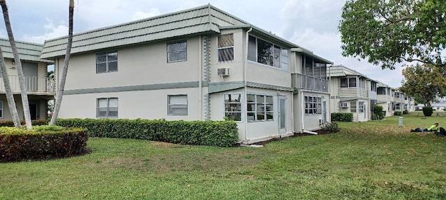 exterior space with a lawn and stucco siding