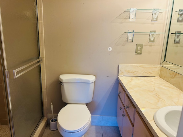 full bath featuring vanity, baseboards, a stall shower, tile patterned flooring, and toilet